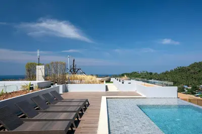 a swimming pool on the roof of a house at Panora Surin by Holy Cow, 1-BR, mountain view in Surin Beach