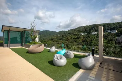 a group of white vases sitting on the grass at Panora Surin by Holy Cow, 1-BR, mountain view in Surin Beach