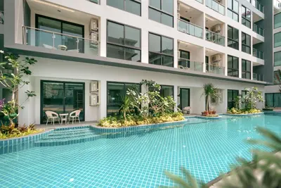 a swimming pool in front of a building at Wekata Luxury in Kata Beach