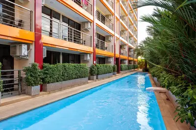 a swimming pool in front of a building at Naiharn Pearl Condo Hotel by VillaCarte in Nai Harn Beach
