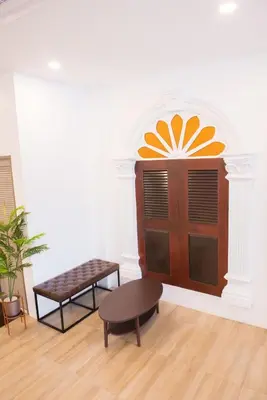 a room with a wooden door and a bench at Mystays Phuket in Phuket Town