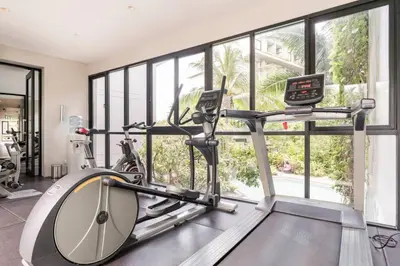 a gym with a treadmill and a large window at Diamond CONDO by VС in Bang Tao Beach