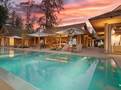a swimming pool in front of a house at Luxury Beachfront Villa Phuket Private Pool Full Staff At Natai Beach in Natai Beach