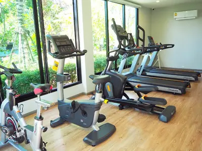a gym with a bunch of exercise bikes in a room at The Title Residencies Naiyang Beach in Nai Yang Beach