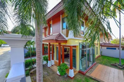 a house with palm trees in front of it at 74 Patong villa walk to Bangla Rd in 10min 3 room cozy modern style in Patong Beach