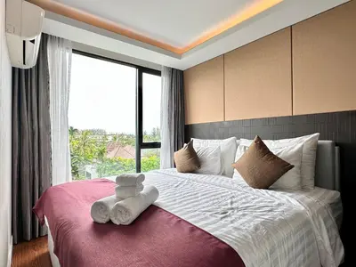 a bedroom with a bed with two teddy bears on it at Aristo Resort Surin Beach S03 in Surin Beach