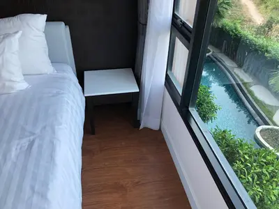 a bedroom with a bed and a window at Aristo Resort Surin Beach S03 in Surin Beach