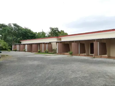 a building with a parking lot in front of it at Nestvilla Khok-kloi Phang-nga in Ban Nai