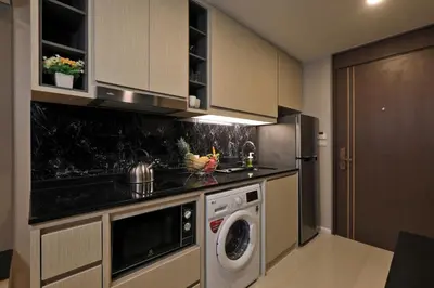 a kitchen with a washer and dryer in it at Sea View 1-BR 36 m2 Panora Surin by Holy Cow in Surin Beach