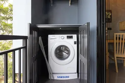 a washer and dryer inside of a house at Relife Windy by Holy Cow, studio with stunning country view in Nai Harn Beach