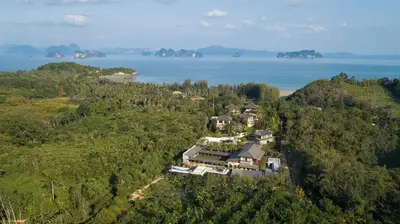 an aerial view of a house on a hill next to the water at SAMSAM Yao Noi - ANDAMAN MAGIC & ART VILLAS in Ko Yao Noi