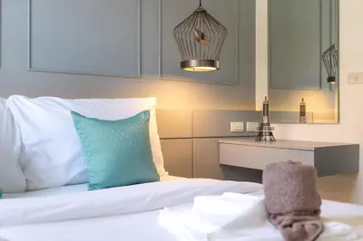 a bedroom with a bed with blue and white pillows at 1BDR Apartment near Surin beach #210 in Surin Beach