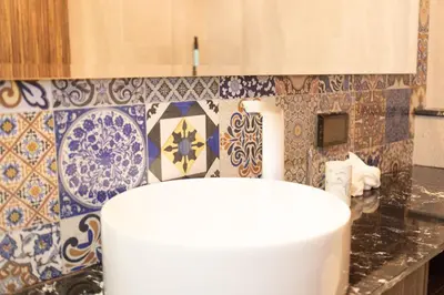 a kitchen with blue and white tiles on the wall at 2BDR Apartment near Surin beach PALM-C703 in Surin Beach