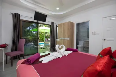 a bedroom with a large bed with a swan on it at Villa Paradise Island in Rawai Beach