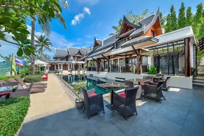 an exterior of a house with a patio and a pool at Baan Yin Dee Boutique Resort Phuket - SHA Plus in Patong Beach