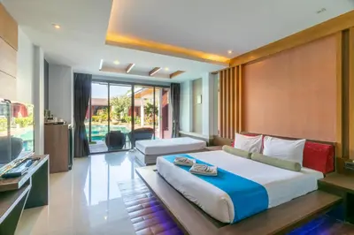 a bedroom with a large bed and a television at Mai Morn Resort SHA Plus in Phuket Town