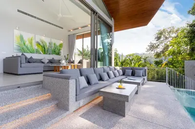 a living room with a couch and a table at Himmapana Villas - Terraces - SHA Extra Plus in Kamala Beach
