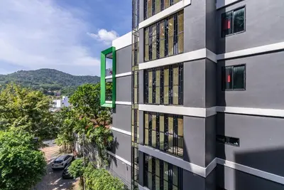 an apartment building with a view of a street at Relife The Windy by VillaCarte in Rawai Beach