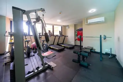 a gym with several tread machines in a room at Mai Khao Beach Condo by VillaCarte in Mai Khao Beach
