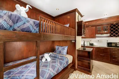 a bedroom with a bunk bed and a kitchen at Patong Tower Sea View by PHR in Patong Beach
