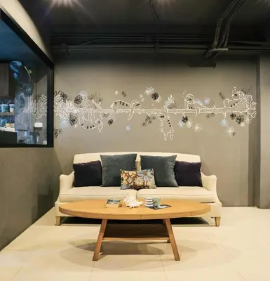 a living room with a couch and a coffee table at TIRAS Patong Beach Hotel in Patong Beach