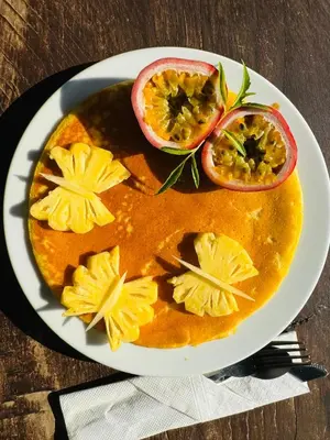 a plate of food with fruit on a table at Hillhouse - Koh Yao Noi in Ko Yao Noi