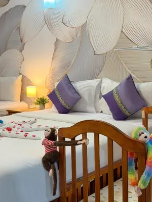 two stuffed animals are sitting on a bed at Chongkhao Resort- Phi Phi Island in Phi Phi Don