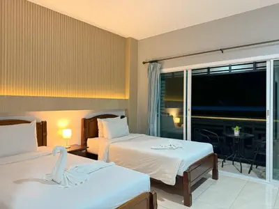 two beds in a hotel room with a swan on them at Chongkhao Resort- Phi Phi Island in Phi Phi Don