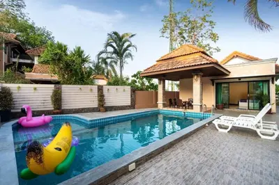 a swimming pool with an inflatable pool toy in a house at Angel Pool Villa Phuket - SHA Extra Plus - indoor Warm pool in Phuket Town