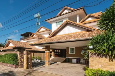 a large house with a driveway at Angel Pool Villa Phuket - SHA Extra Plus - indoor Warm pool in Phuket Town