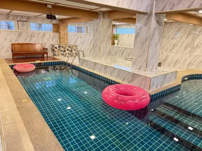 a swimming pool with a red frisbee in it at Angel Pool Villa Phuket - SHA Extra Plus - indoor Warm pool in Phuket Town