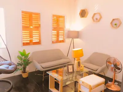 a living room with two chairs and a table at Primego Boutique Hotel in Phuket Town