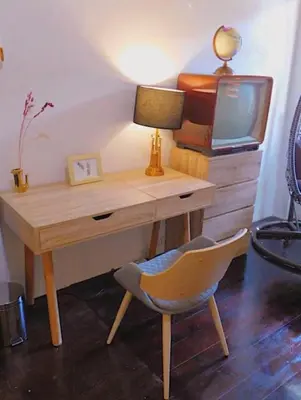 a desk with a lamp and a chair and a television at Primego Boutique Hotel in Phuket Town