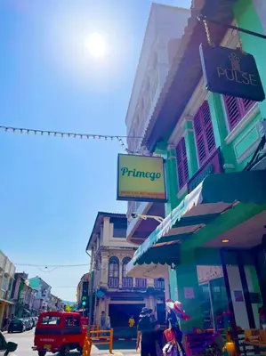 a street with a pharmacy sign on a building at Primego Boutique Hotel in Phuket Town