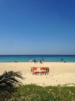 a beach with a table and chairs on the sand at KARON SINO House in Karon Beach