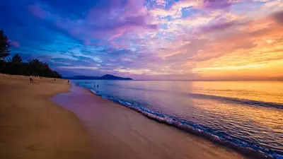 a beach with a cloudy sky and the ocean at APARTMENTS MBC in Mai Khao Beach