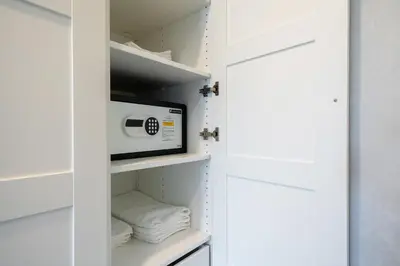 a closet with a microwave and towels at Luxury Apartment at Title Residencies Naiyang Beach in Phuket Town