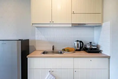 a kitchen with a sink and a counter top at The Apartment at The Title Residencies Naiyang Beach in Phuket Town