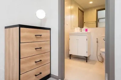 a bathroom with a dresser and a toilet at The Apartment at The Title Residencies Naiyang Beach in Phuket Town