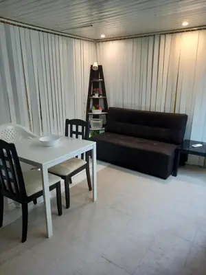 a living room with a couch and a table and chairs at Kata Happy Place in Kata Beach