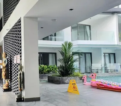 a building with a swimming pool and a house at CYAN Resort Kamala Beach Apartments Condominiums in Kamala Beach