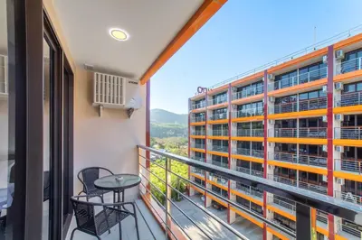 a balcony with a view of a building at LUMA Condo 1BR Open View NBC Nai Harn in Rawai Beach