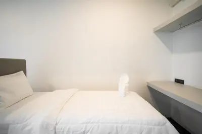a bedroom with a white bed and a desk at Pine Bungalow Krabi in Klong Muang Beach
