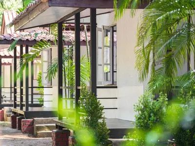a building with a bench in front of it at Sand Beach Bungalow in Klong Muang Beach