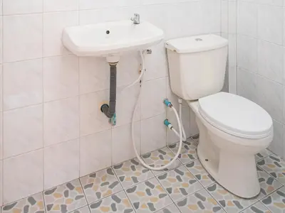 a bathroom with a toilet and a sink at Sand Beach Bungalow in Klong Muang Beach