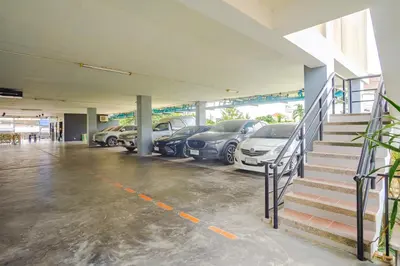 a parking lot with cars parked in a garage at AJ Residence in Phuket Town
