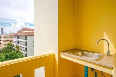 a bathroom with a sink and a window at AJ Residence in Phuket Town