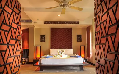 a bedroom with a bed and a ceiling fan at Kata Beach Aspasia Boutique Apartment in Kata Beach
