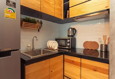 a kitchen with a sink and a microwave at Cozy design studio near Nai Harn beach in Nai Harn Beach