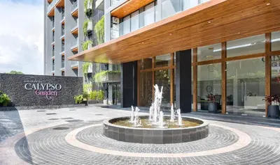a fountain in a courtyard in front of a building at Calypso Garden by Villacarte in Rawai Beach